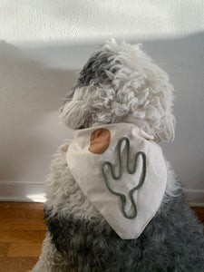 old english sheepdog wearing a bandana adorned with a golden sun and sage cactus  